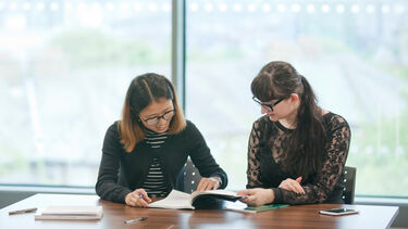 Two Education postgraduates at table