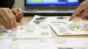 A close up of students discussing their planning work - image 