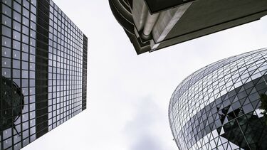 A view looking up at three skyscrapers