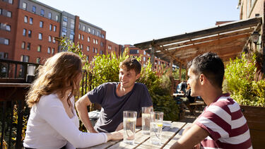 Sheffield students sitting outside with drinks in Kelham Island