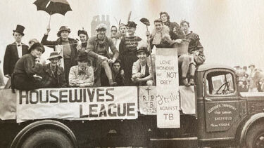 A black-and-white image of Jack and his RAG friends dressed up on the back of a flatbed truck