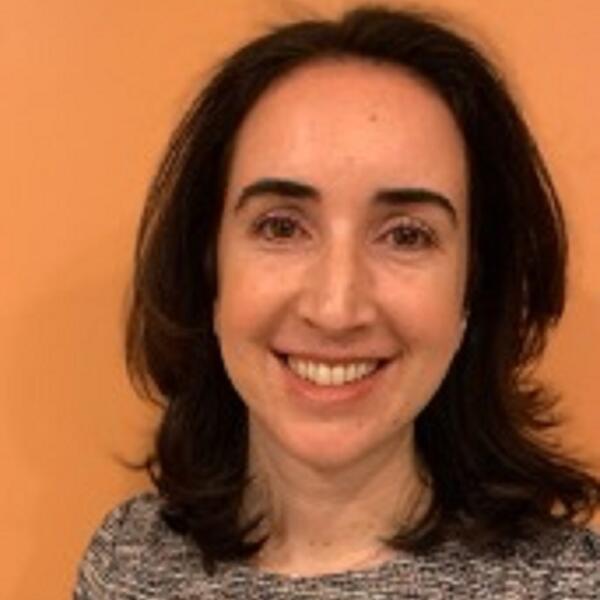 Profile picture of Laura M Maratou-Kolias in front of an orange wall