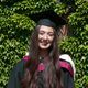 A woman wearing a graduation cap and gown