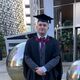 Image of male student Harry baker in his graduation cap and gown