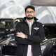 Anish is standing in from of a Bentley car