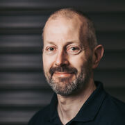 A head and shoulders photo of Adrian Sharman