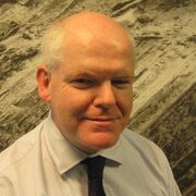 A man in a checked shirt with dark tie