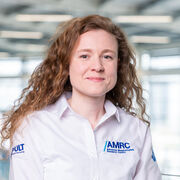 Female with curly hair in white AMRC uniform